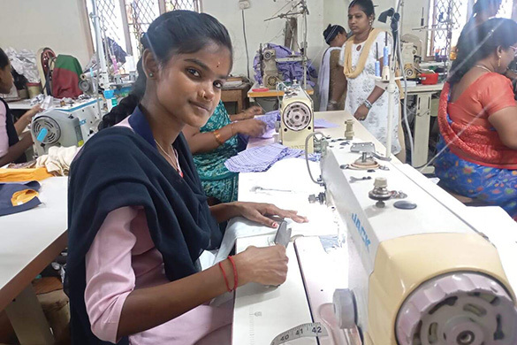 Somwya sewing in home economics class. 